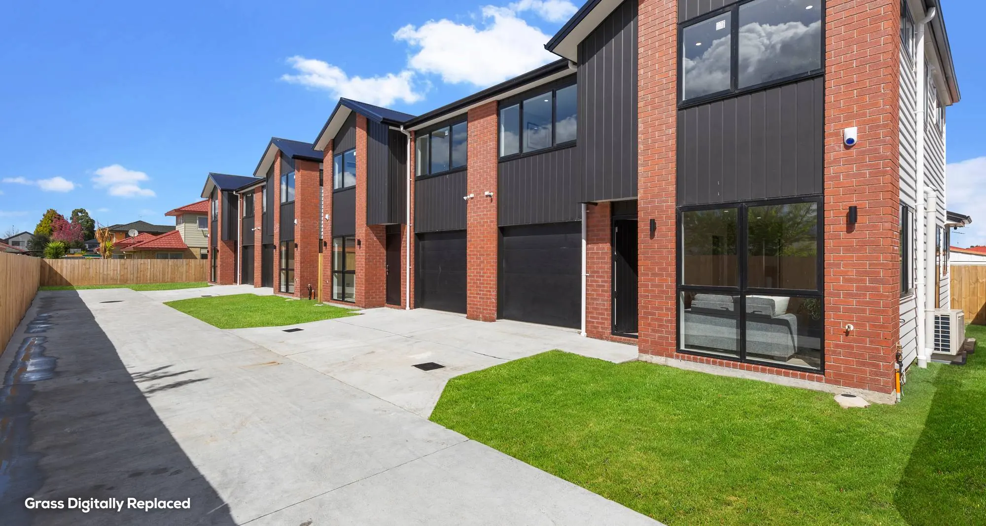 Old Wairoa Road townhouses — brick and dark cladding
